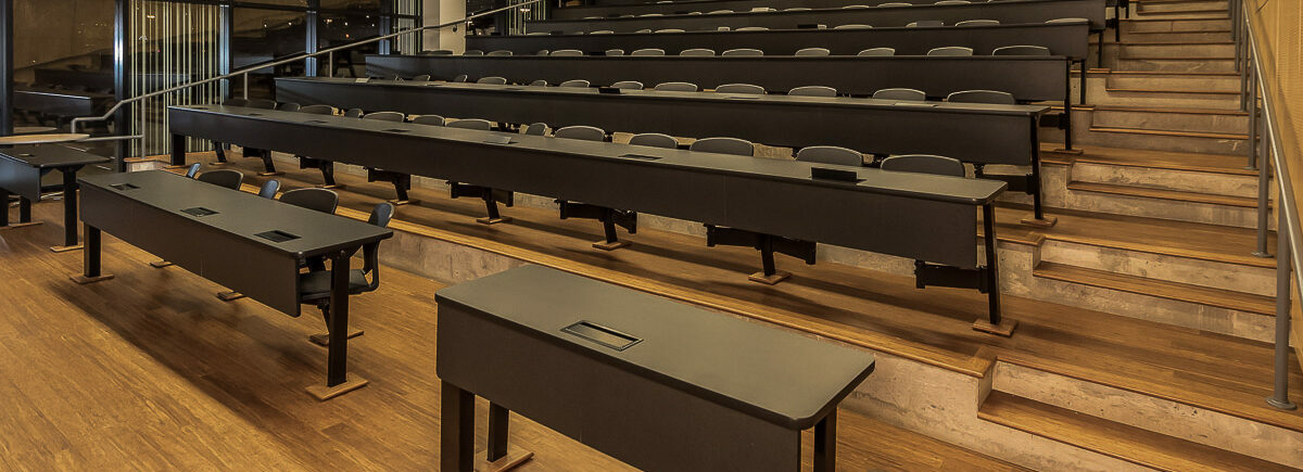 Stadium style Lecture Hall with rows of tables and chairs